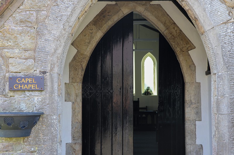 black wooden doors into a small chapel